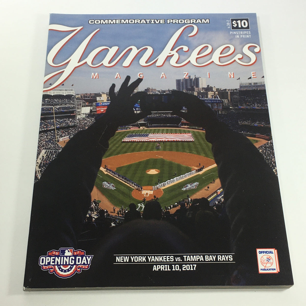 Cover image of Yankees Magazine: April 10, 2017 Volume 38-2, featuring the New York Yankees vs Tampa Bay Rays, showcasing a baseball field from a fan's perspective during the opening day.