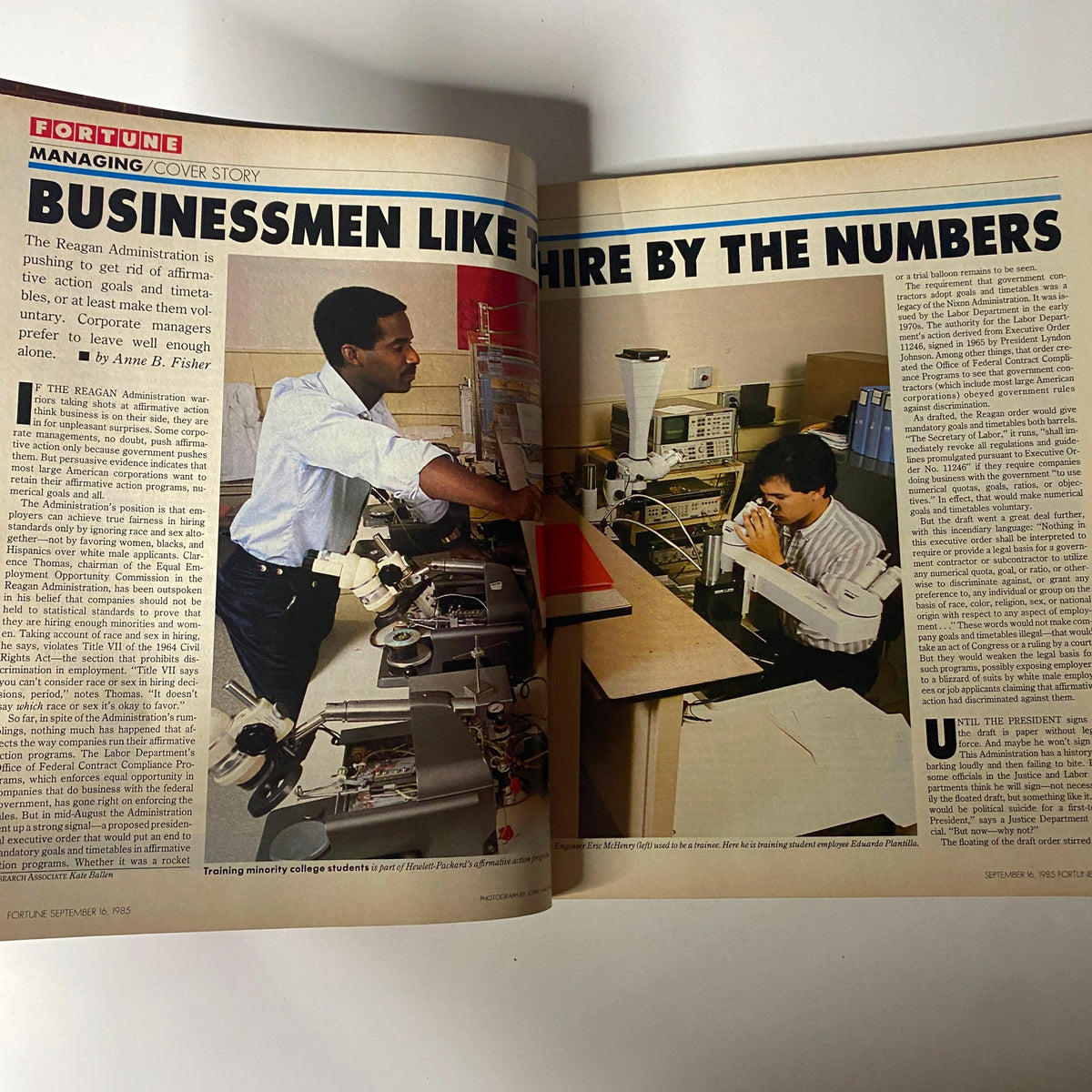 Interior page of Fortune Magazine September 16, 1985, showcasing the cover story 'Businessmen Like to Hire by the Numbers' which discusses the Reagan Administration's approach to affirmative action in hiring. The image features two individuals working in an office setting.