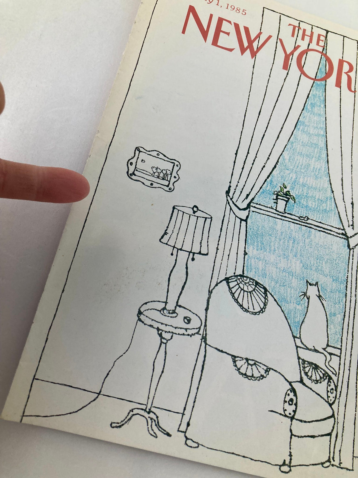 Artistic illustration of The New Yorker July 1, 1985 cover by Robert Tallon, featuring a minimalist design with a window view, a chair, a lamp, and a cat, showcasing the cultural essence of the 1980s.