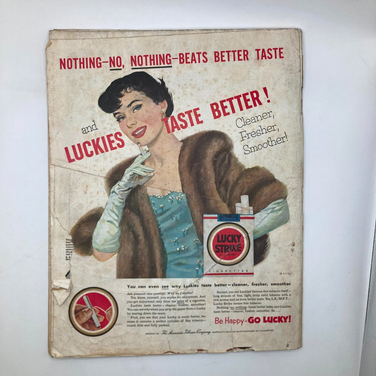 Vintage advertisement from Saturday Evening Post Magazine March 7 1953 featuring a glamorous woman in a blue dress with a fur stole promoting Lucky Strike cigarettes, emphasizing their superior taste.