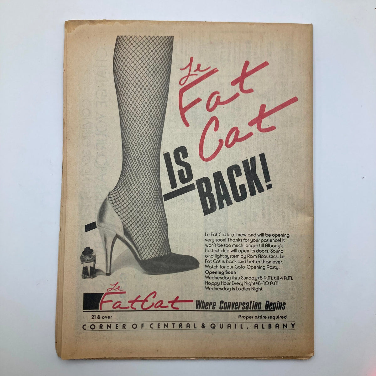 Vintage Metroland Magazine cover from December 15, 1983, showcasing an advertisement for 'Le Fat Cat' with a high heel shoe and fishnet stocking design, celebrating last-minute Christmas shopping.