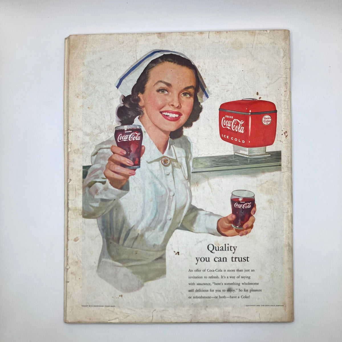 Advertiser page from the Saturday Evening Post Magazine March 22 1952 featuring a vintage Coca-Cola advertisement with a smiling woman offering drinks.