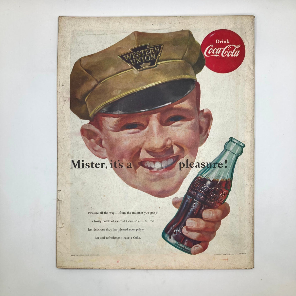 Back cover of the January 26, 1952 Saturday Evening Post magazine, featuring a vintage Coca-Cola advertisement with a smiling boy in a Western Union cap.
