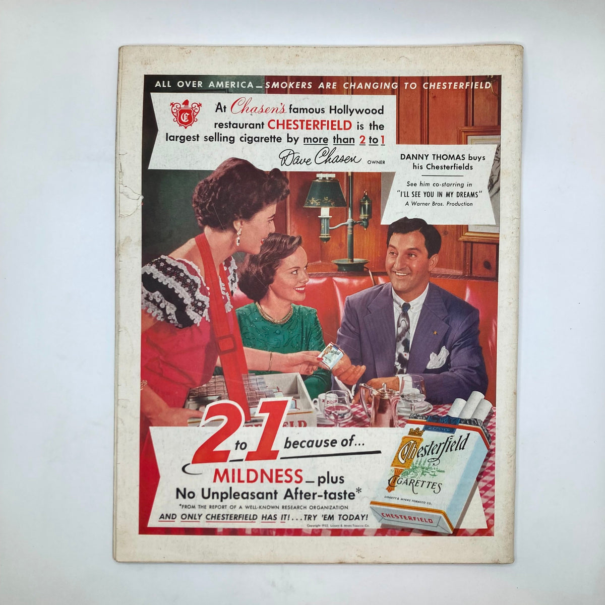 Back cover of Saturday Evening Post Magazine March 8 1952 advertising Chesterfield cigarettes, featuring a scene in a restaurant with patrons and a waiter.