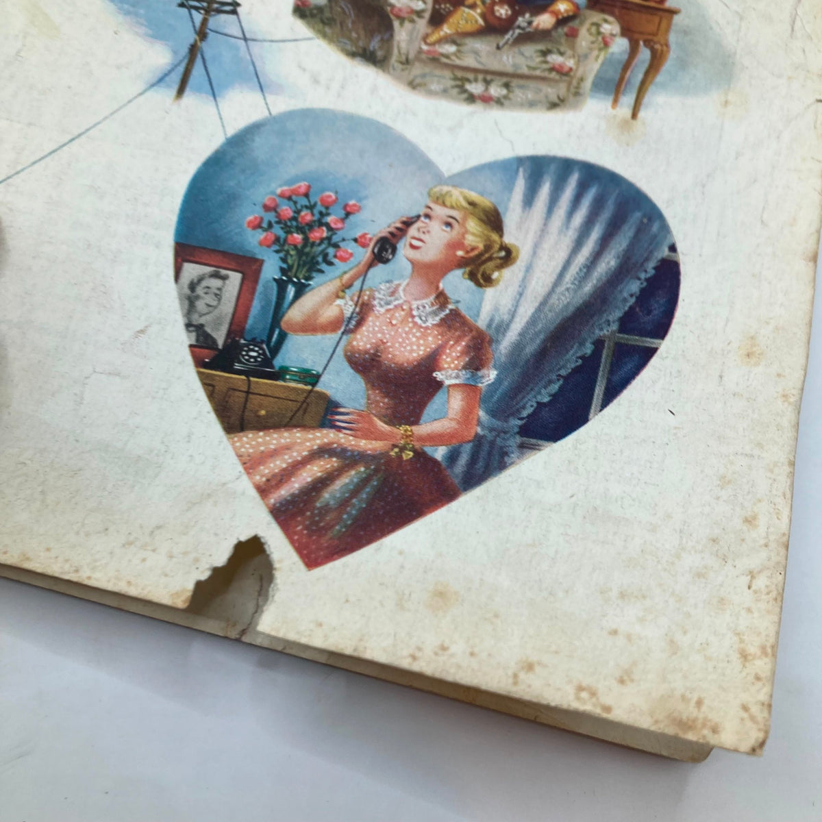 Detailed view of a heart-shaped illustration from the Saturday Evening Post Magazine June 7, 1952 depicting a woman on the phone.