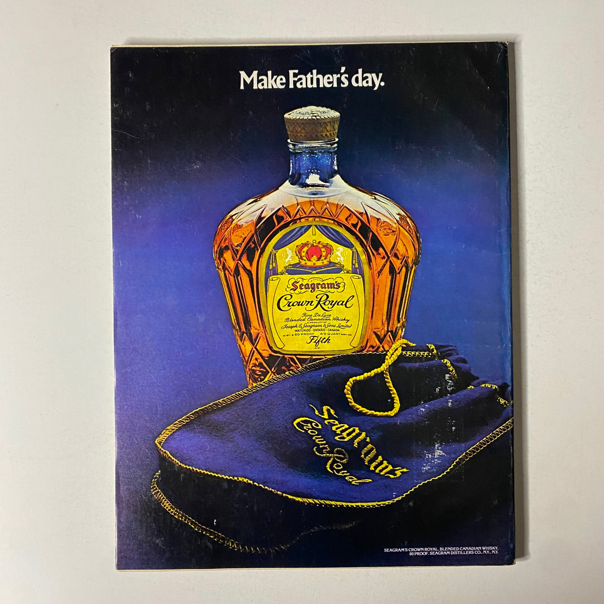 Advertisement from Esquire Magazine June 1977 for Seagrams Crown Royal, promoting a whiskey gift idea with a vibrant visual showcasing the bottle and branding.