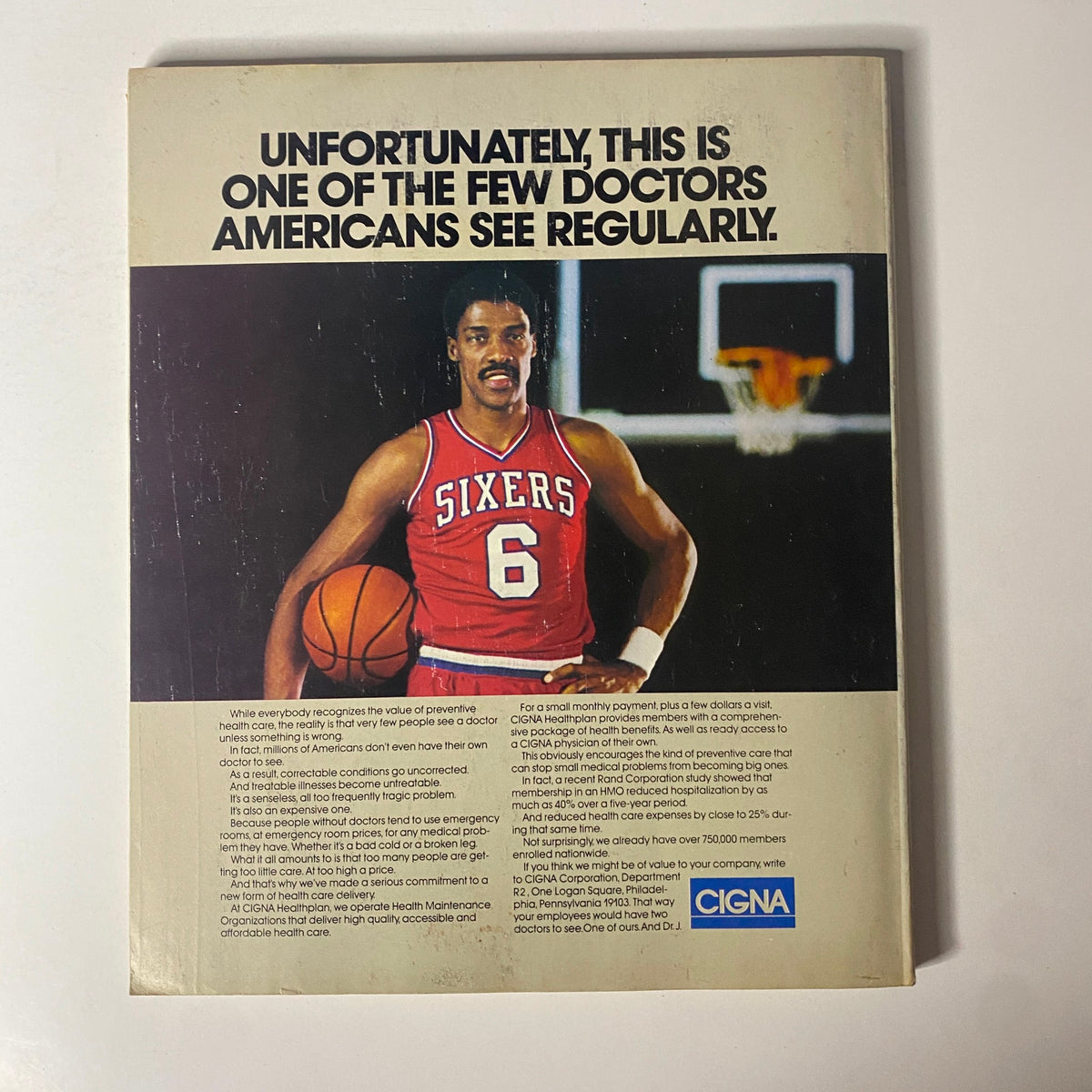 Back cover of Fortune Magazine from June 10, 1985, showcasing an advertisement by CIGNA featuring a basketball player, addressing preventive healthcare in a humorous context.
