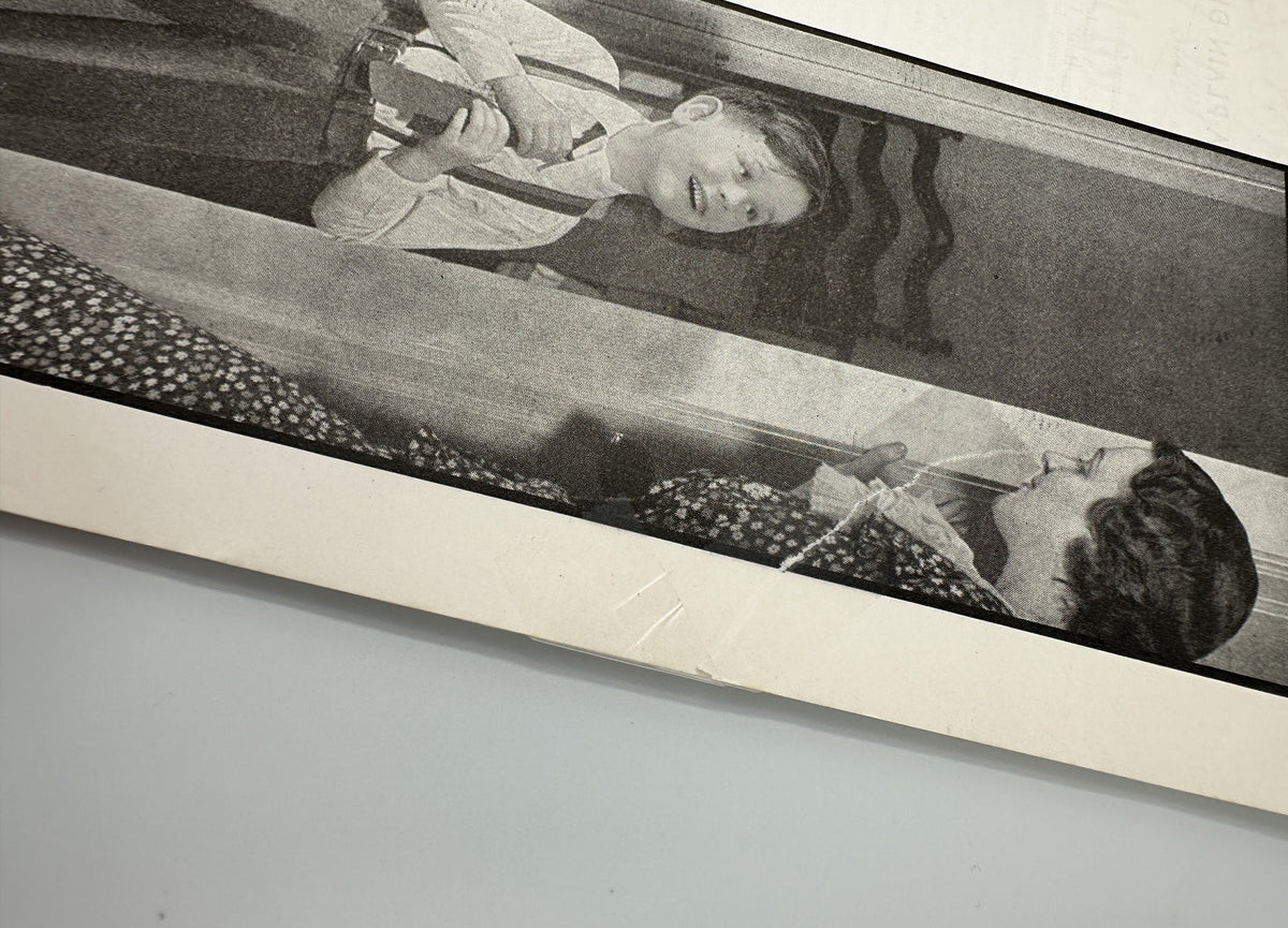 Black and white photo from Better Homes & Gardens Magazine September 1935 featuring a young boy in a striped outfit interacting with a woman, highlighting family themes in home and lifestyle.