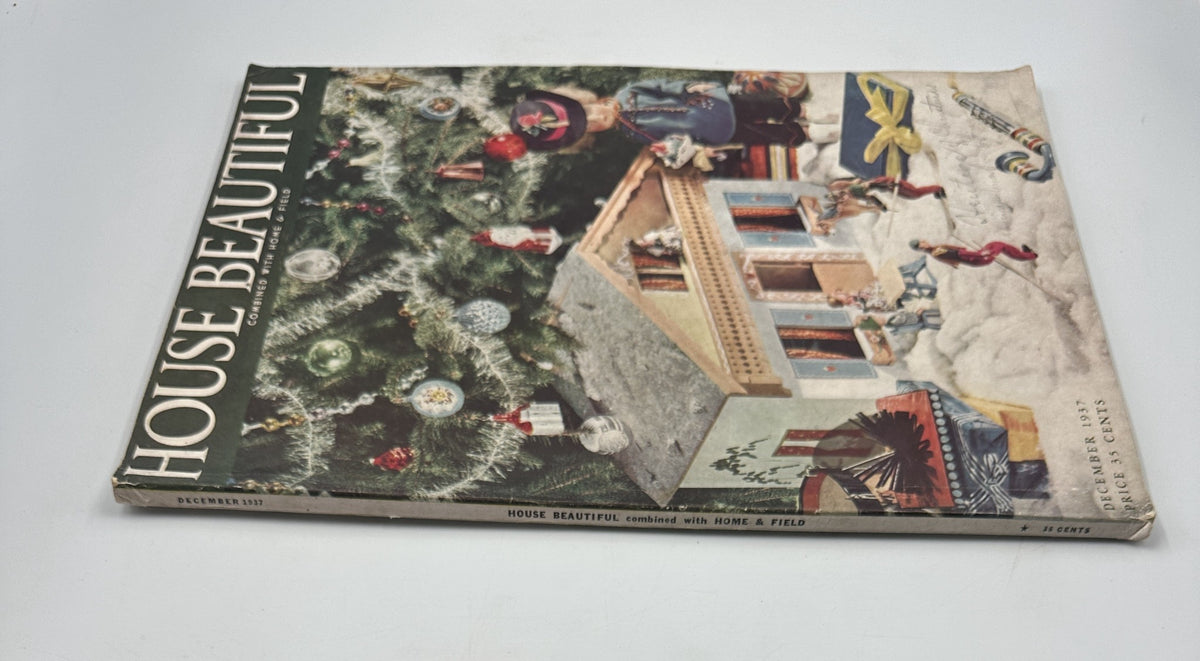House Beautiful Magazine from December 1937, featuring a picturesque Christmas scene with a decorated tree, playful toys, and a quaint house. Ideal for fans of historical home decor and holiday inspiration.