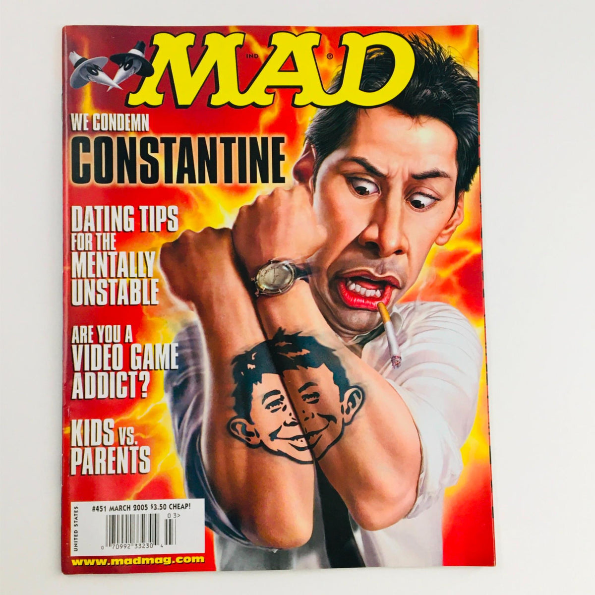 Mad Magazine March 2005 No. 451 featuring Constantine on the cover, showcasing a humorous illustration with a character holding a cigarette, depicting satire and pop culture themes.
