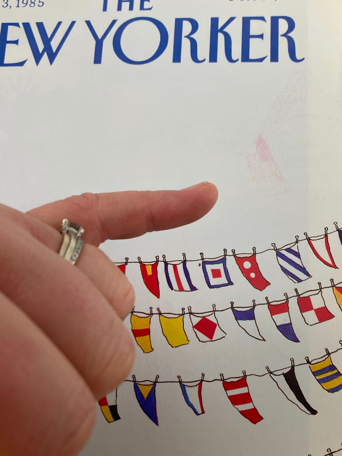 Close-up detail of The New Yorker June 3, 1985 cover artwork 'Flags' by Heidi Goennel, highlighting colorful flags and a character pointing at them, demonstrating the whimsical design characteristic of the publication.