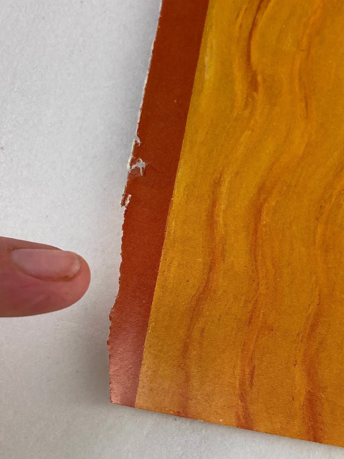 Close-up detail of the edge of the October 16 1989 The New Yorker cover, showing wear and tear with a finger pointing to the damaged area.