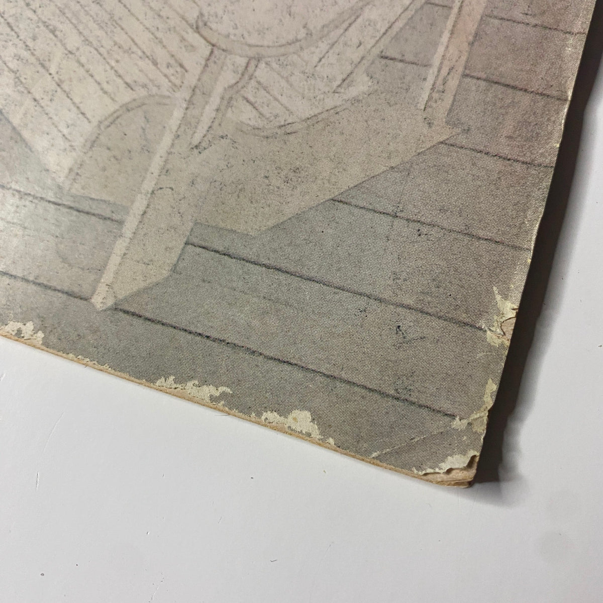 Close-up view of the edge of The New Yorker magazine cover from July 18, 1977, showcasing the age-related wear and tear on the iconic cover illustrated by Charles E. Martin.