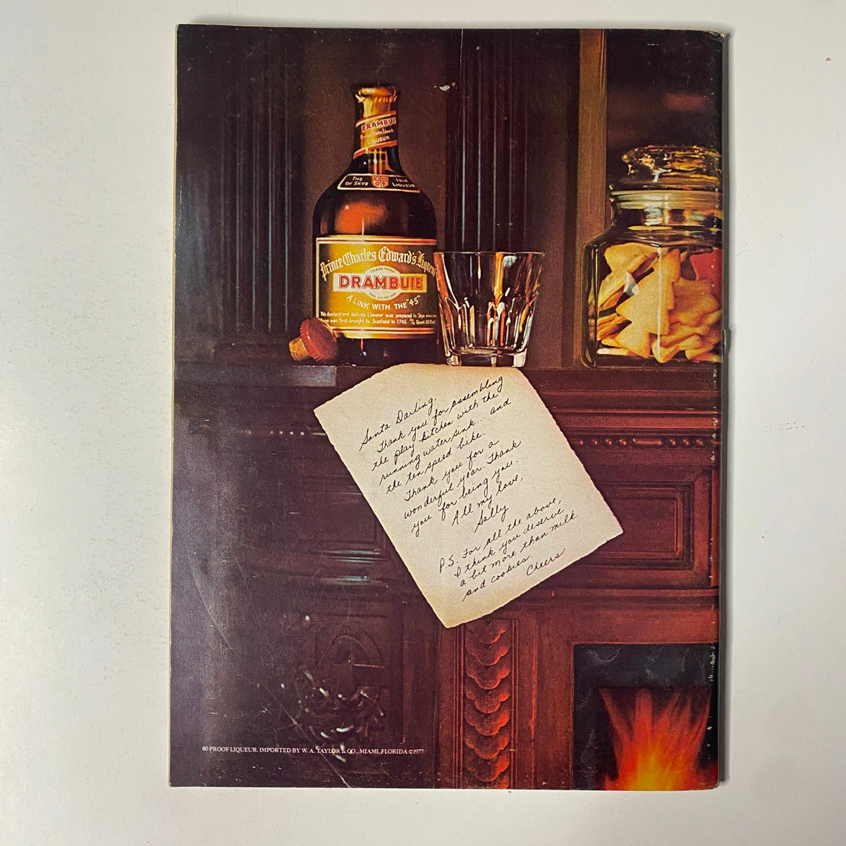 Advertisement page from The New Yorker Full Magazine December 19, 1977 showcasing a bottle of Drambuie and a handwritten note.