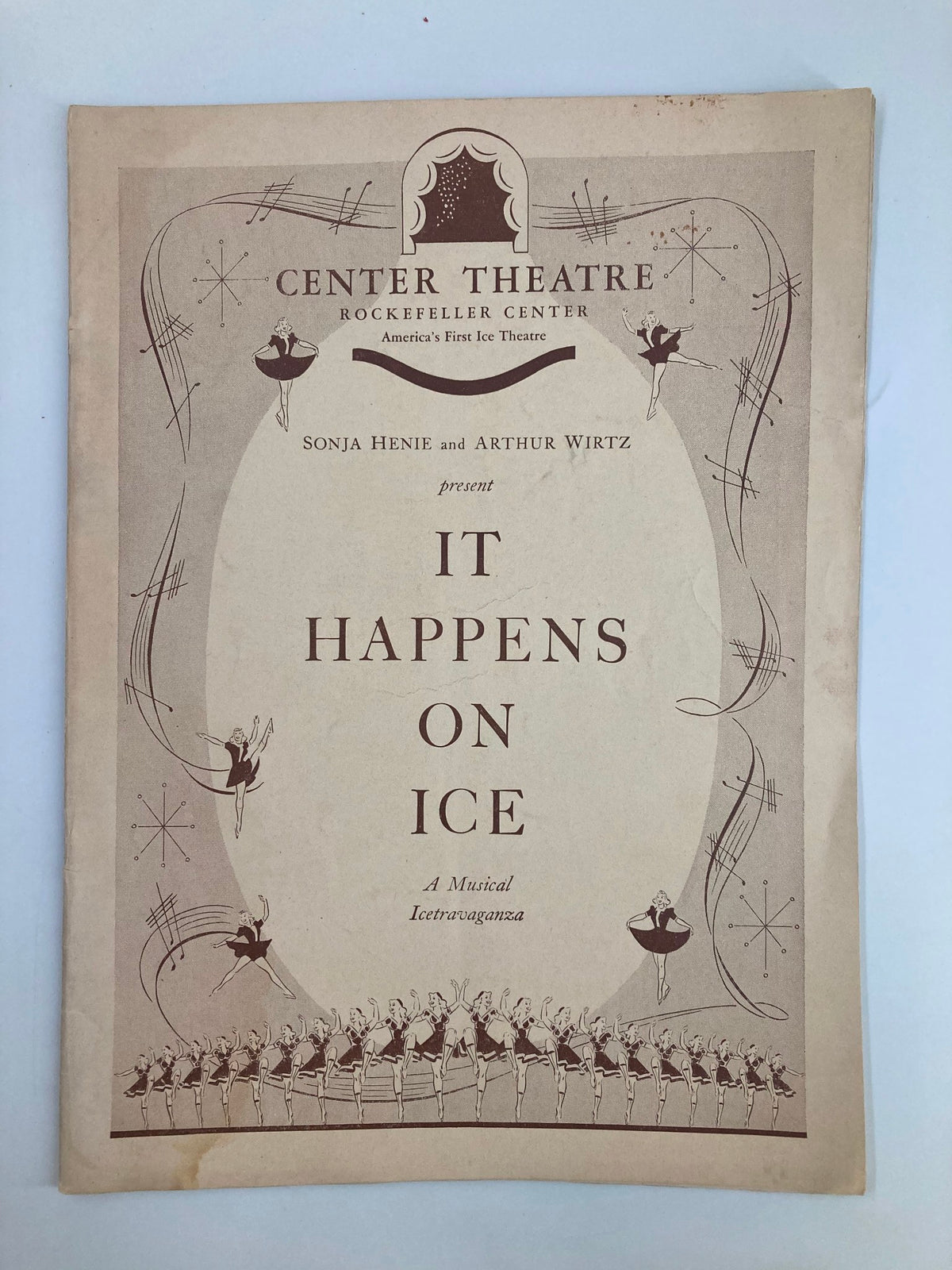 1940 Center Theatre Playbill for 'It Happens On Ice' featuring Sonja Henie and Arthur Wirtz, showcasing vintage design and artistic elements.