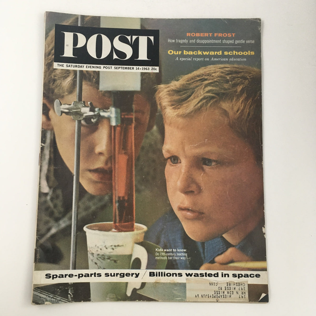Cover of The Saturday Evening Post from September 14, 1963 featuring Robert Frost and the article 'Our Backward Schools,' showcasing young boys engaged in science experiment, reflecting on education and societal issues.