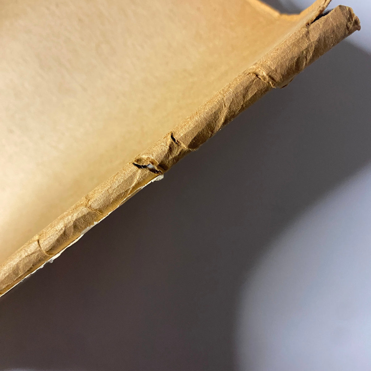 Close-up view of the spine of The New Yorker Full Magazine April 28, 1975, highlighting the wear and tear characteristic of vintage magazines.