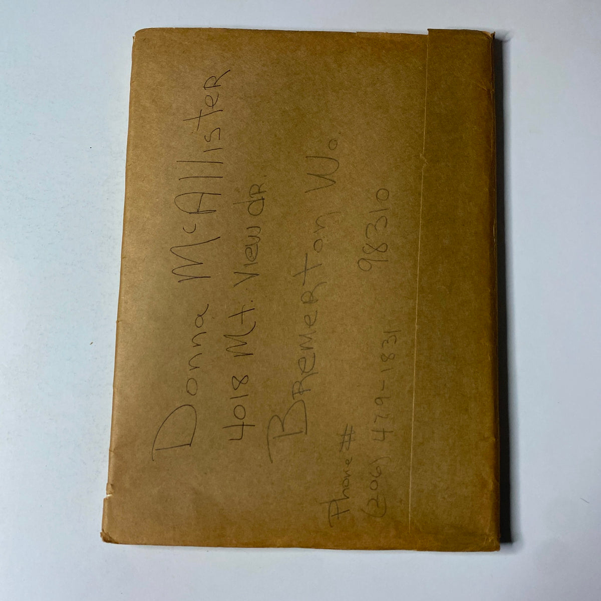 Brown paper envelope with handwritten address, associated with The New Yorker magazine, showcasing a vintage mailing style.