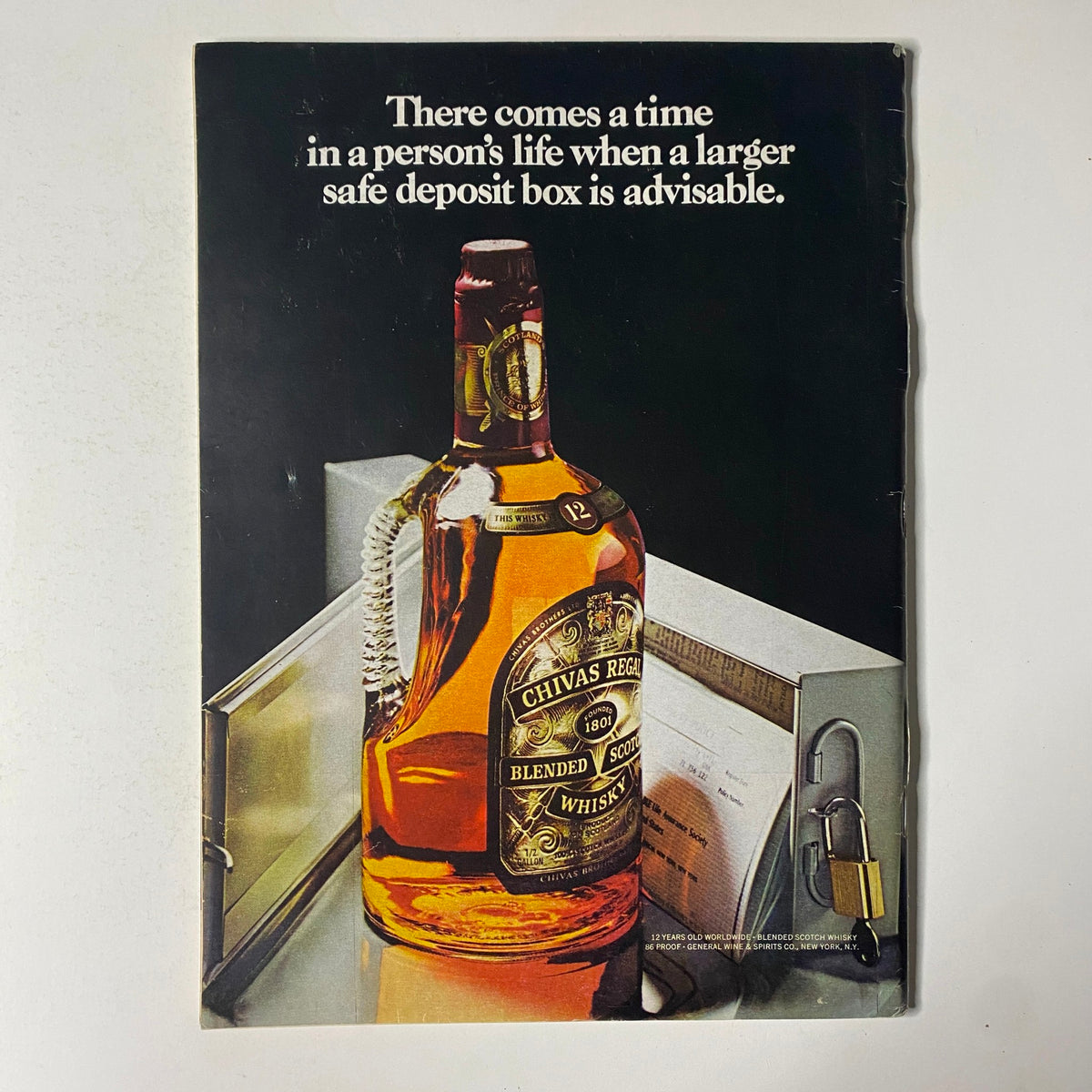 Back cover advertisement from The New Yorker Full Magazine April 7, 1975, showcasing a bottle of Chivas Regal whiskey, accompanied by a text about safe deposit boxes.