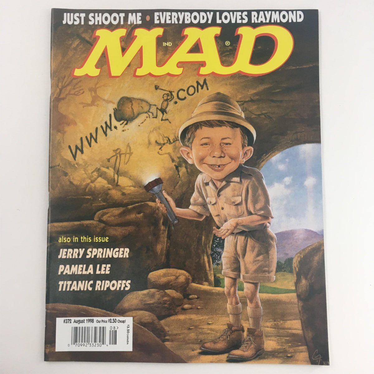 Cover of Mad Magazine August 1998 No. 372 featuring Alfred Neuman exploring a cave, showcasing humorous artwork and playful elements typical of the series.