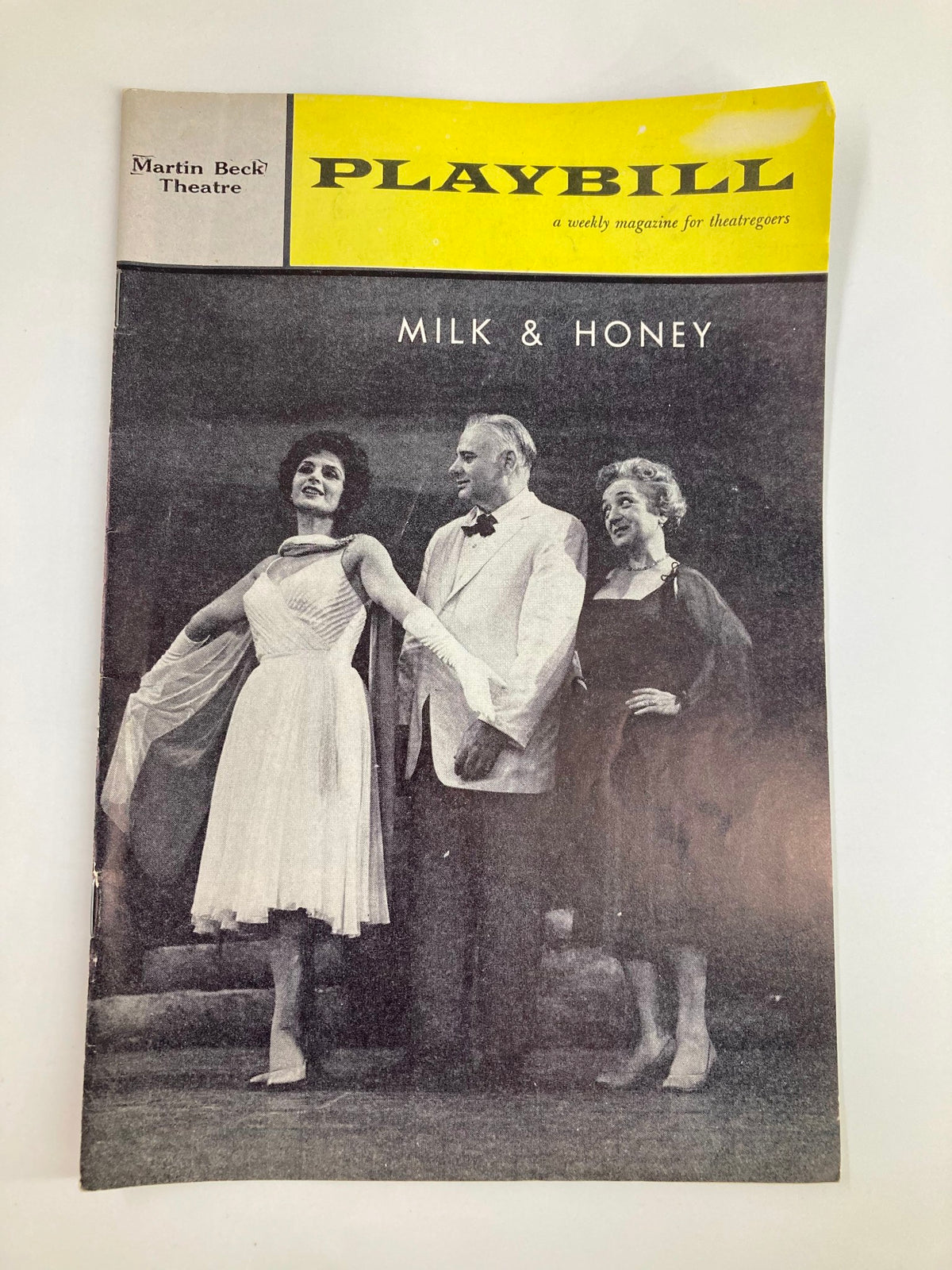 1962 Playbill from the Martin Beck Theatre featuring the musical 'Milk and Honey' with actors in performance attire. This vintage magazine showcases the historical significance of the Tony Award-winning production starring Robert Weede and Tommy Rall.