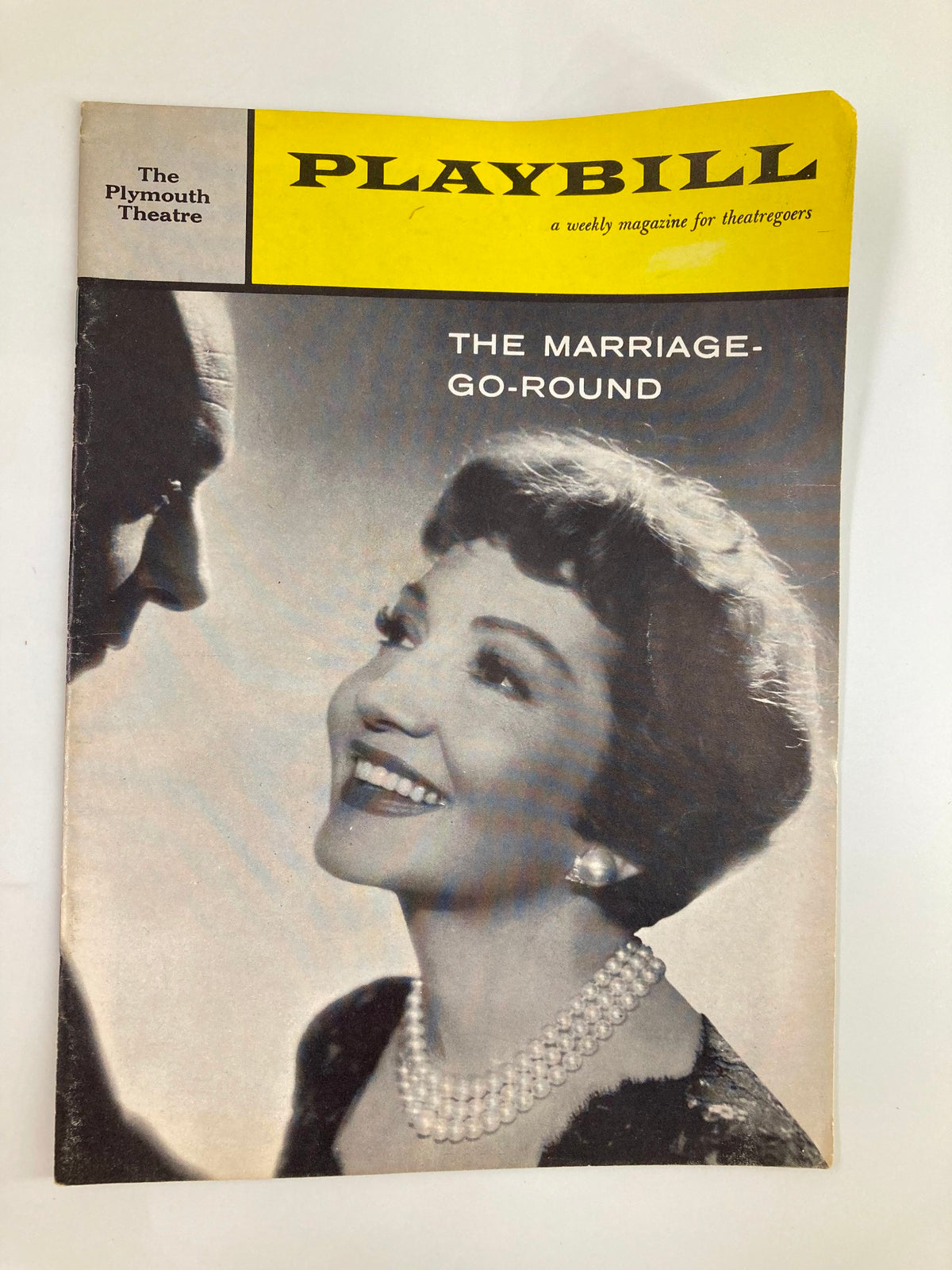 1959 Playbill The Plymouth featuring Claudette Colbert in The Marriage-Go-Round, showcasing a black and white photograph of Colbert smiling, adorned with pearls.