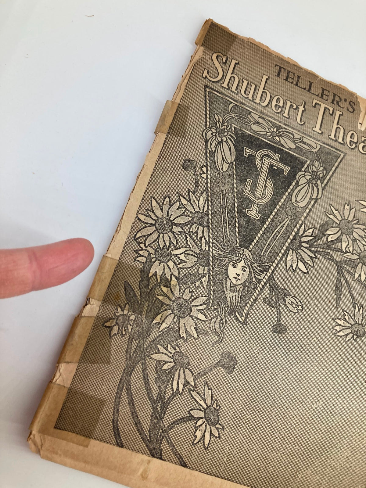 Detailed view of the cover of the 1917 Teller's Shubert Theatre Pollyanna The Glad Play by Catherine C. Cushing, showcasing floral designs and wear, ideal for vintage theater memorabilia collectors.