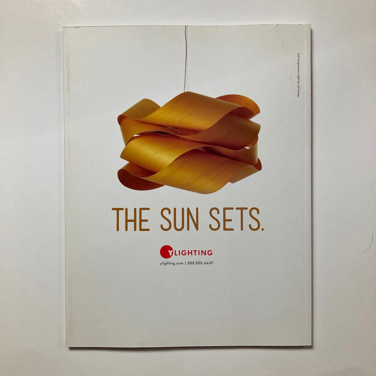 Cover of Atomic Ranch Magazine Spring 2014 titled 'Modern Makeover on a Budget' featuring a stylish light fixture and the phrase 'THE SUN SETS.' This vintage magazine is a resource for design enthusiasts focusing on affordable renovations.