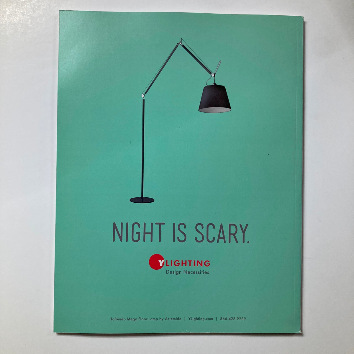 Advertisement from Atomic Ranch Magazine Summer 2014, featuring a creative illustration of a floor lamp with the tagline 'Night is Scary' by YLighting.