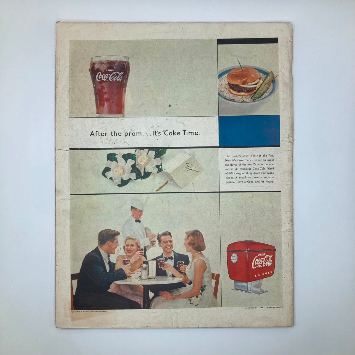 Back cover of the Saturday Evening Post Magazine, February 20, 1954, showcasing a Coca-Cola advertisement surrounded by images of a refreshing drink, a burger, and a joyful gathering after prom.