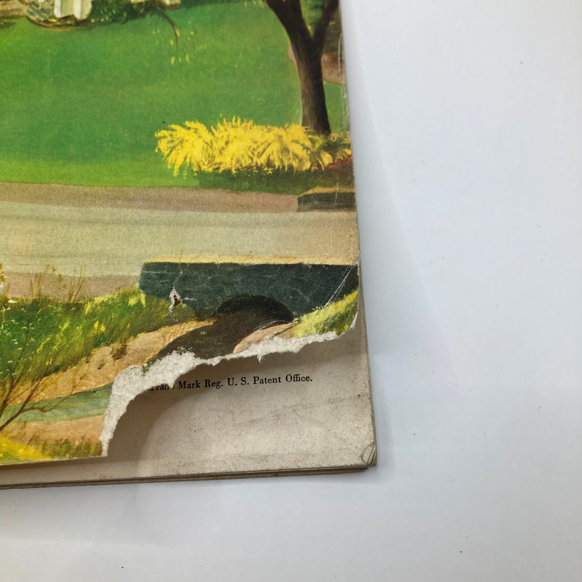 Detailed view of the edge of the Saturday Evening Post Magazine May 29 1954 cover showing minor wear.