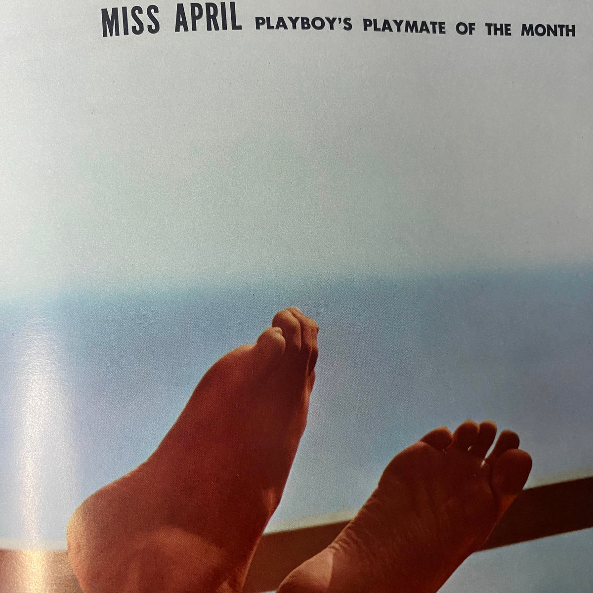 Page from Playboy Magazine April 1966 showcasing Playmate of the Month, Miss April, with an artistic view of feet on a balcony overlooking the ocean.
