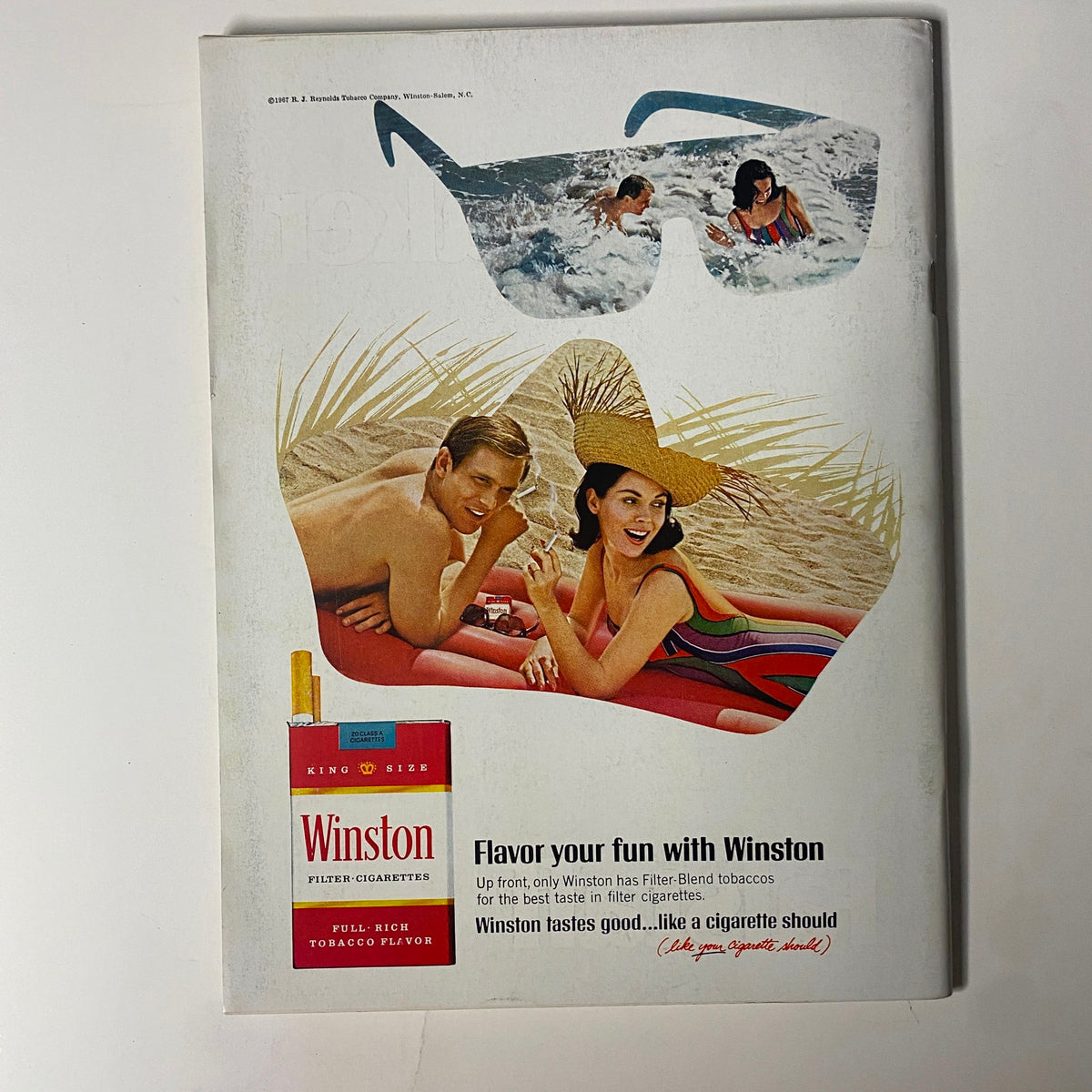 Playboy Magazine August 1968 featuring a vintage advertisement for Winston cigarettes, showcasing two people at the beach enjoying summer, accompanied by a stylish illustration of sunglasses and a pack of Winston cigarettes. Ideal for collectors of retro magazine ads.