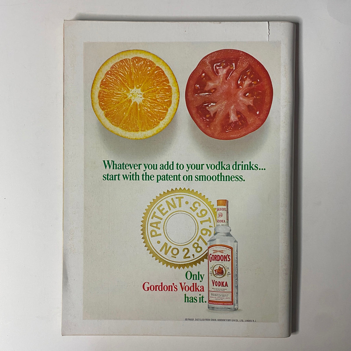 Back cover advertisement of Gordon's Vodka in May 1968 Playboy Magazine, featuring a design with a bottle, orange, and tomato.