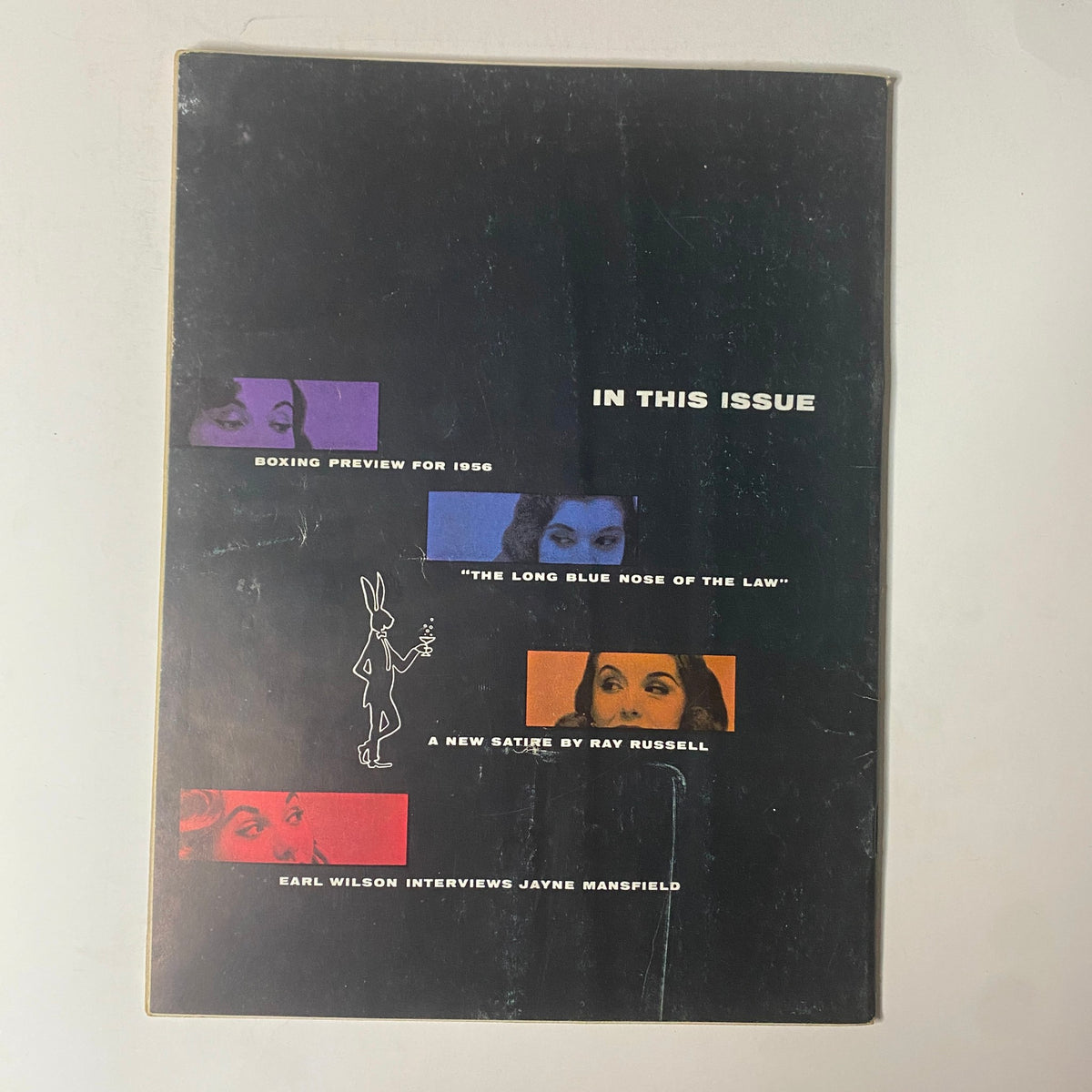 Back cover of Playboy Magazine February 1956, showcasing an overview of featured articles, including boxing previews and an interview with Jayne Mansfield.