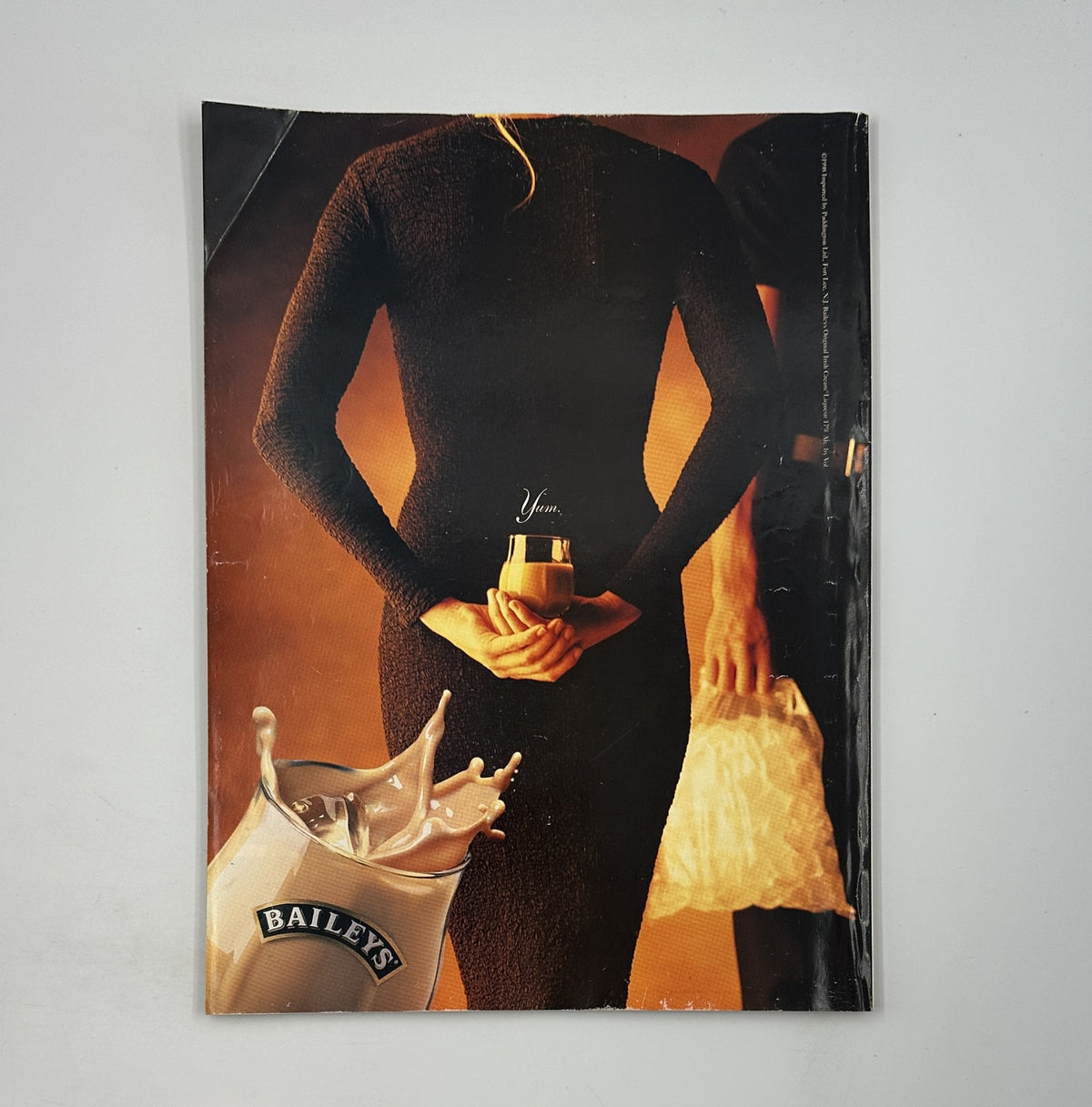 The back cover of George Magazine April 1998 featuring an advertisement for Bailey's with a stylish model holding a drink, encapsulating the allure and sophistication of the era.