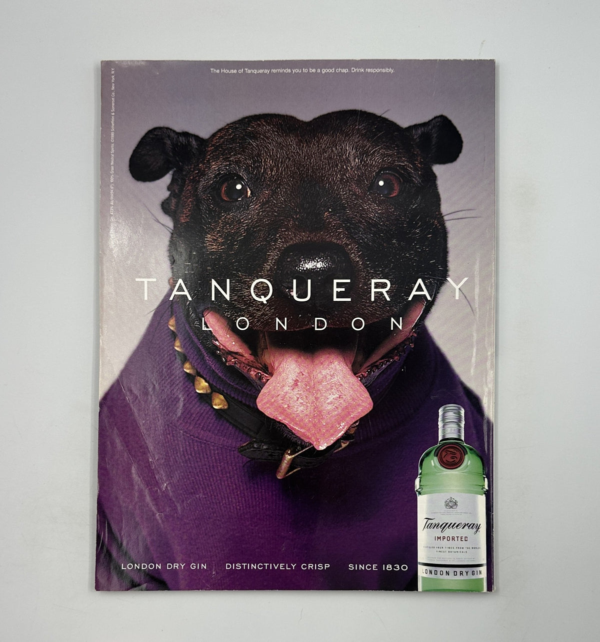 Tanqueray advertisement featuring a dog with a playful expression, on the back cover of George Magazine December 2000.