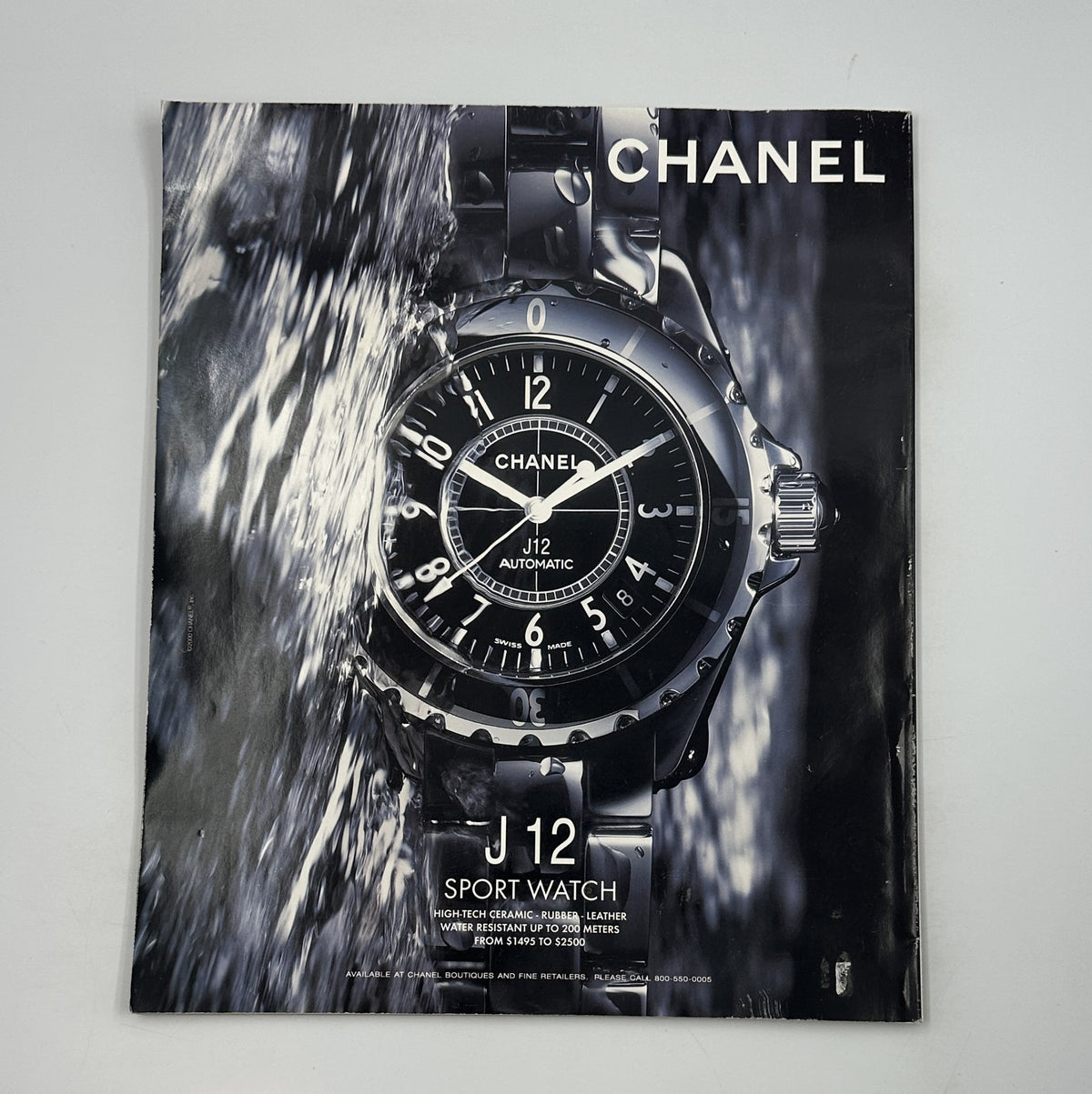 Advertisement for the Chanel J12 Sport Watch featured in George Magazine November 2000, showcasing luxury timepiece design against a water backdrop.