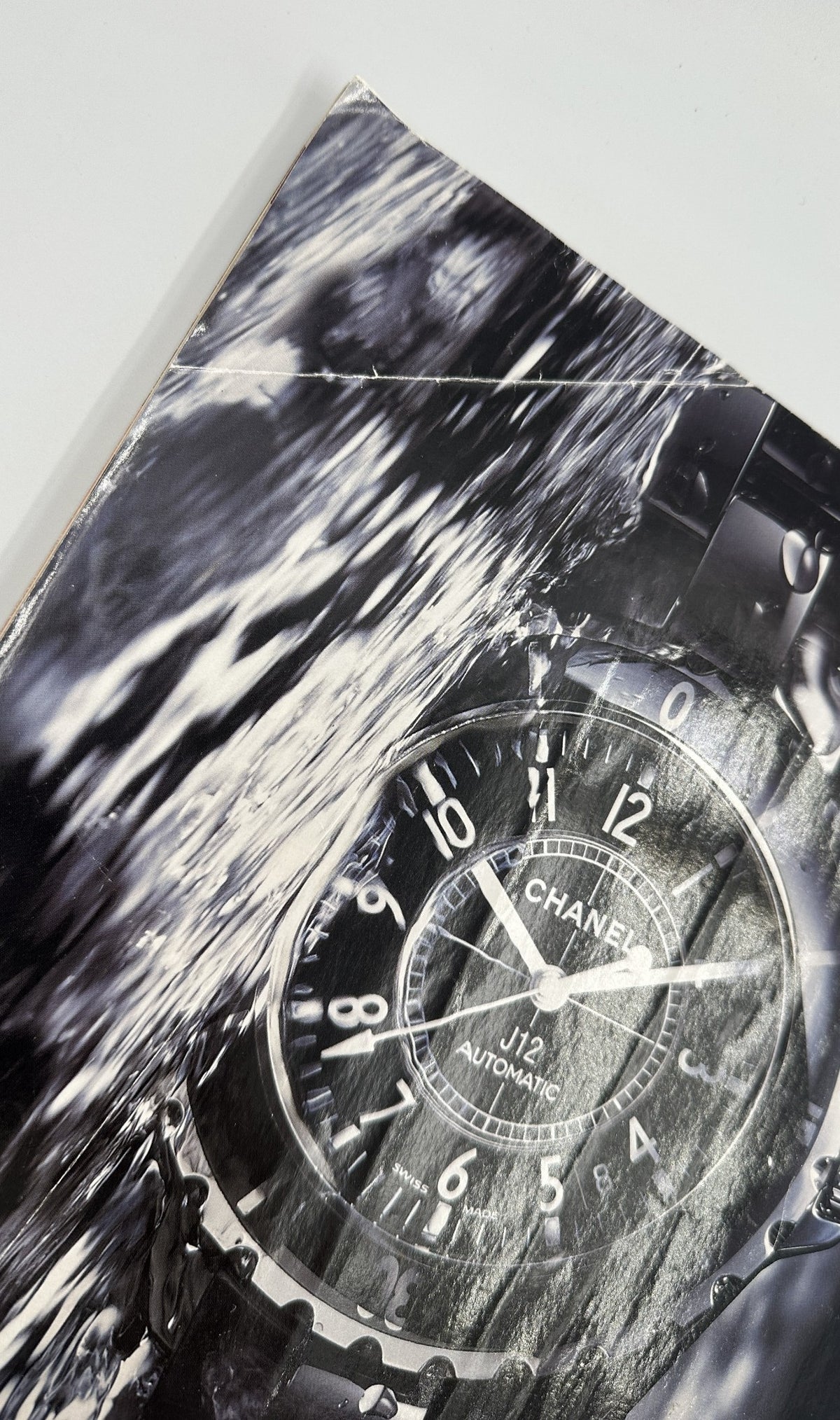 Close-up of a Chanel watch advertisement from the Farewell Issue of George Magazine, showcasing luxury and style.