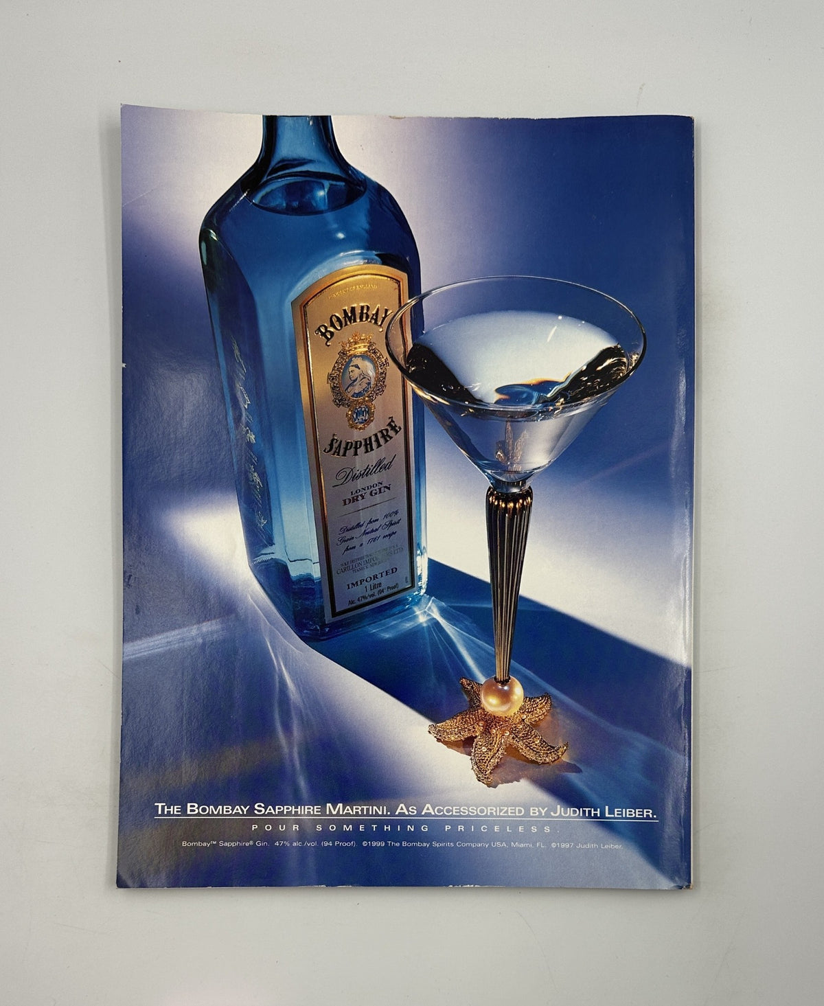 Advertisement for Bombay Sapphire Martini from George Magazine October 1999, featuring an artistic display of the gin bottle and glass, emphasizing luxury and sophistication.