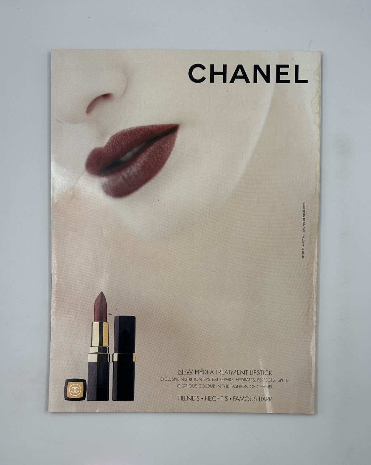 Chanel advertisement featuring a close-up of lips with deep red lipstick, promoting New Hydra-Treatment Lipstick with SPF 15, an aesthetically captivating image from a vintage magazine.