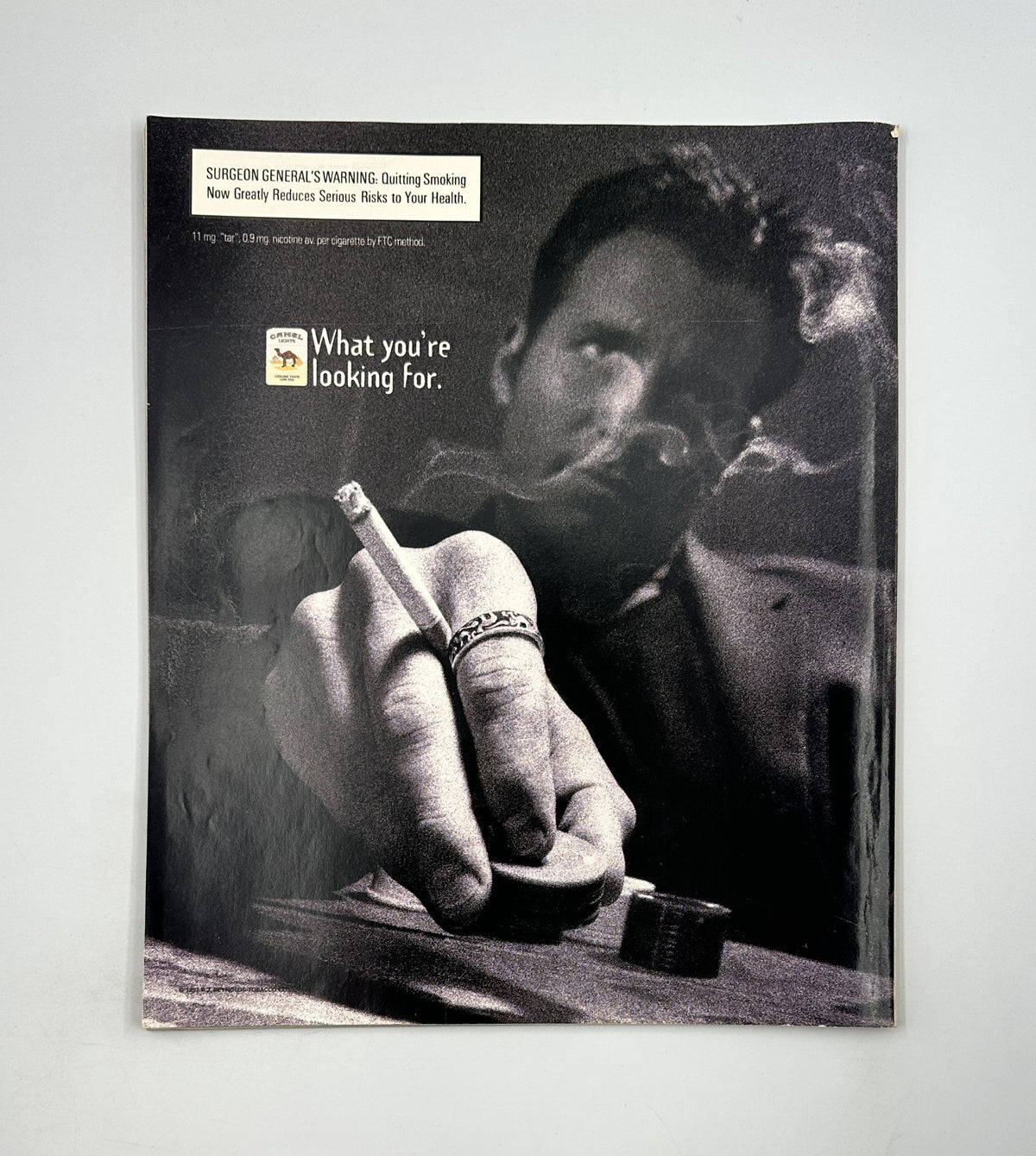 Illustrative ad encouraging smoking cessation, showing a close-up of a man's hand holding a cigarette, with the text 'What you're looking for.' Featured in George Magazine October 1997, including interviews with Elizabeth Hurley, the Dalai Lama, and Chris Rock.