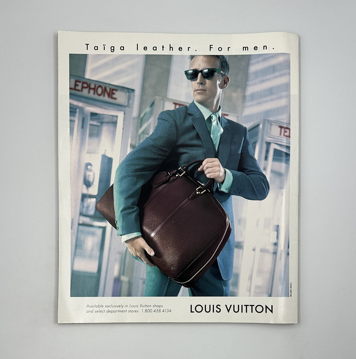 Louis Vuitton advertisement showcasing a fashionable man in a suit and sunglasses, promoting Taiga leather bags, found in George Magazine September 1997.