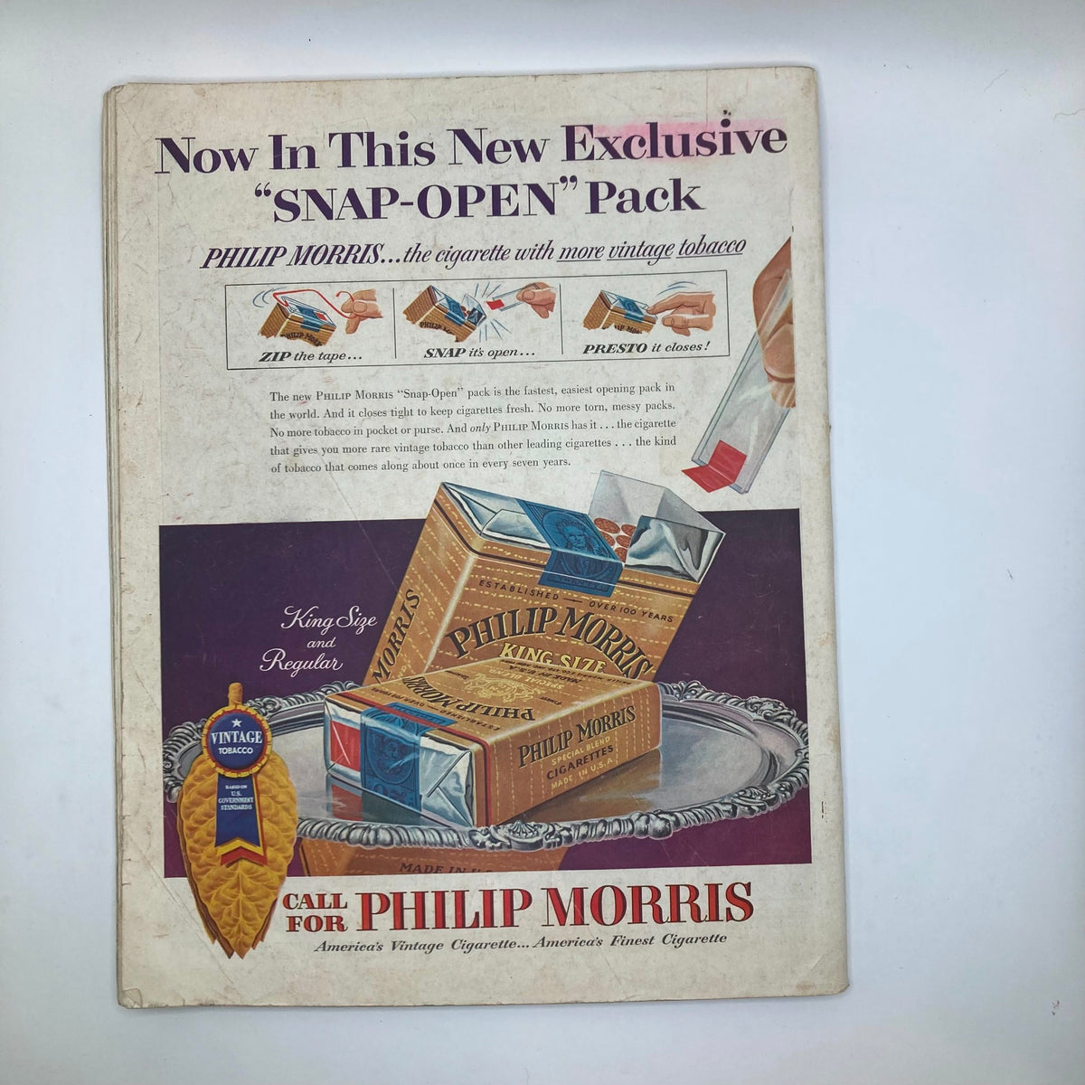 Advertisement page from the Saturday Evening Post Magazine, May 8, 1954, featuring the new 'Snap-Open' pack for Philip Morris cigarettes.