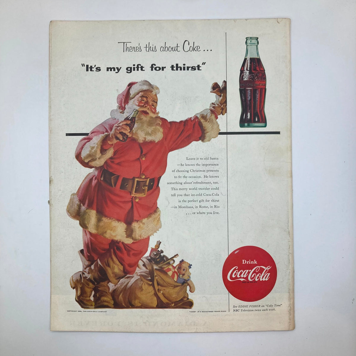 Advertisement page from Saturday Evening Post Magazine December 23 1954 Christmas featuring Santa Claus promoting Coca-Cola as the perfect gift for thirst.