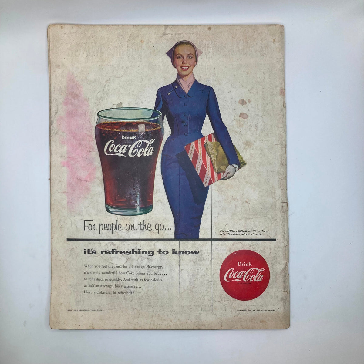 Back cover of the Saturday Evening Post Magazine from October 30, 1954 displaying a vintage Coca-Cola advertisement featuring a smiling woman and a glass of Coke.