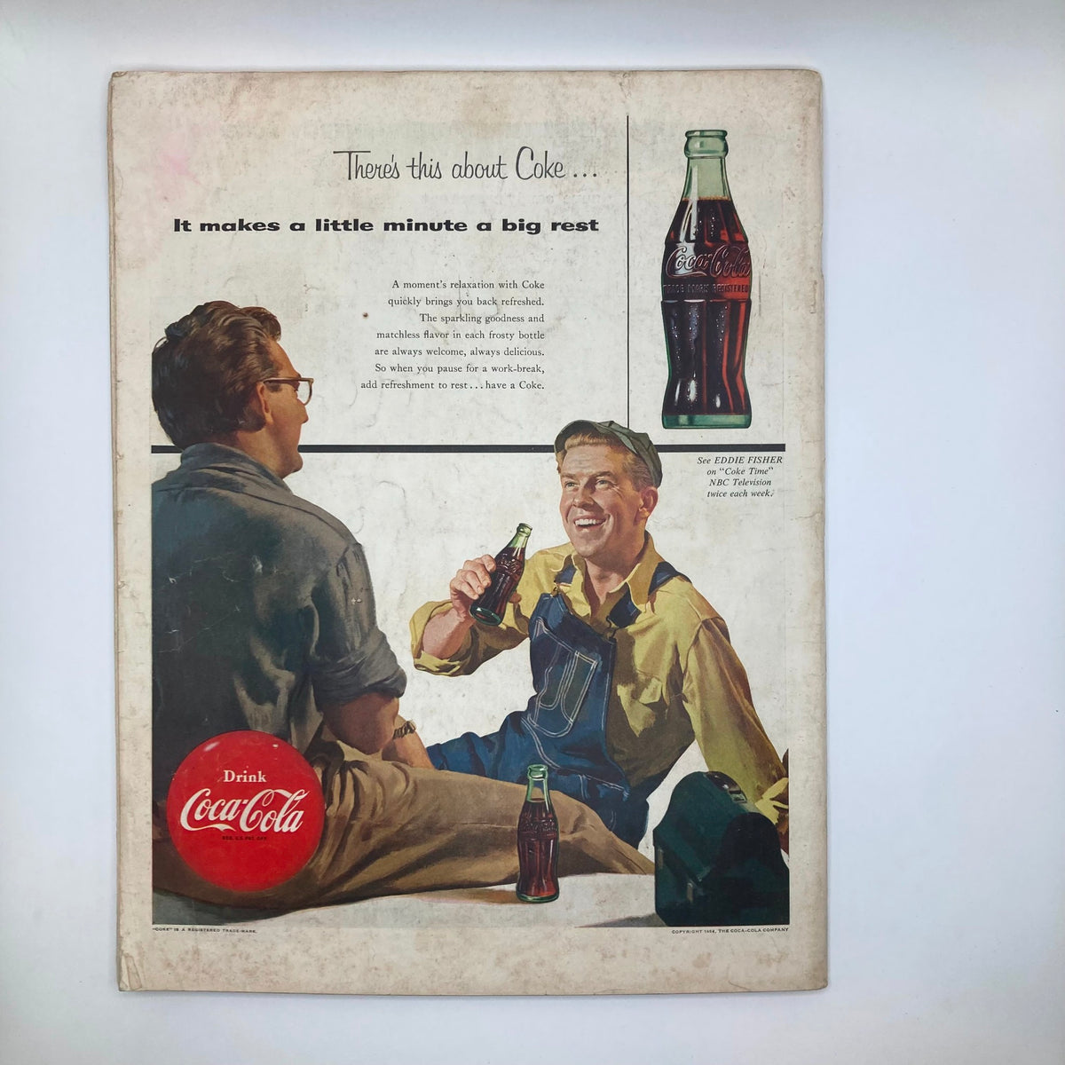 Back cover of Saturday Evening Post Magazine April 17 1954 featuring an advertisement for Coca-Cola, showcasing two men enjoying a break with bottles of Coke, promoting refreshment and relaxation.