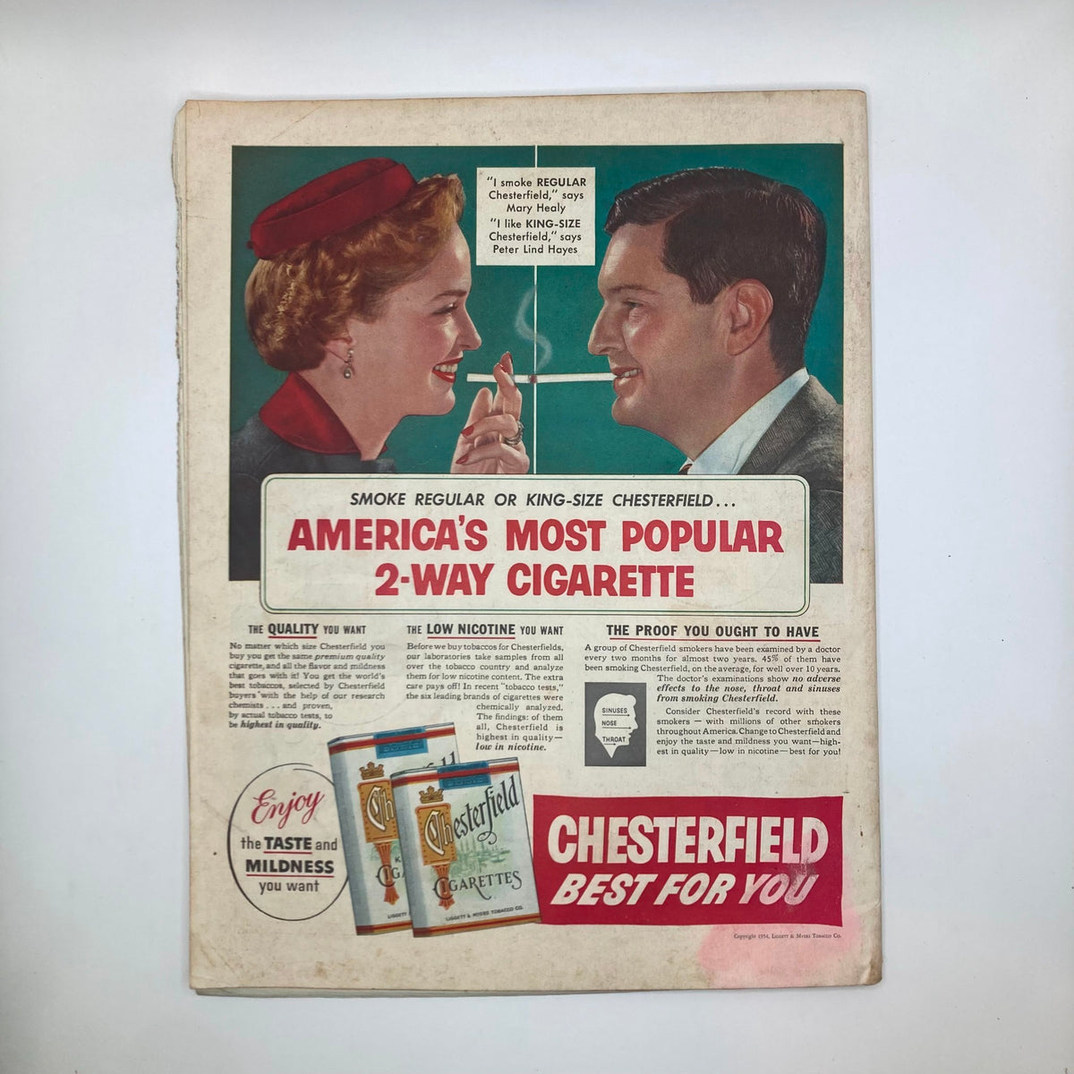 Back cover of Saturday Evening Post Magazine April 3, 1954 displaying a colorful Chesterfield cigarette advertisement featuring a couple smoking and promotional text.