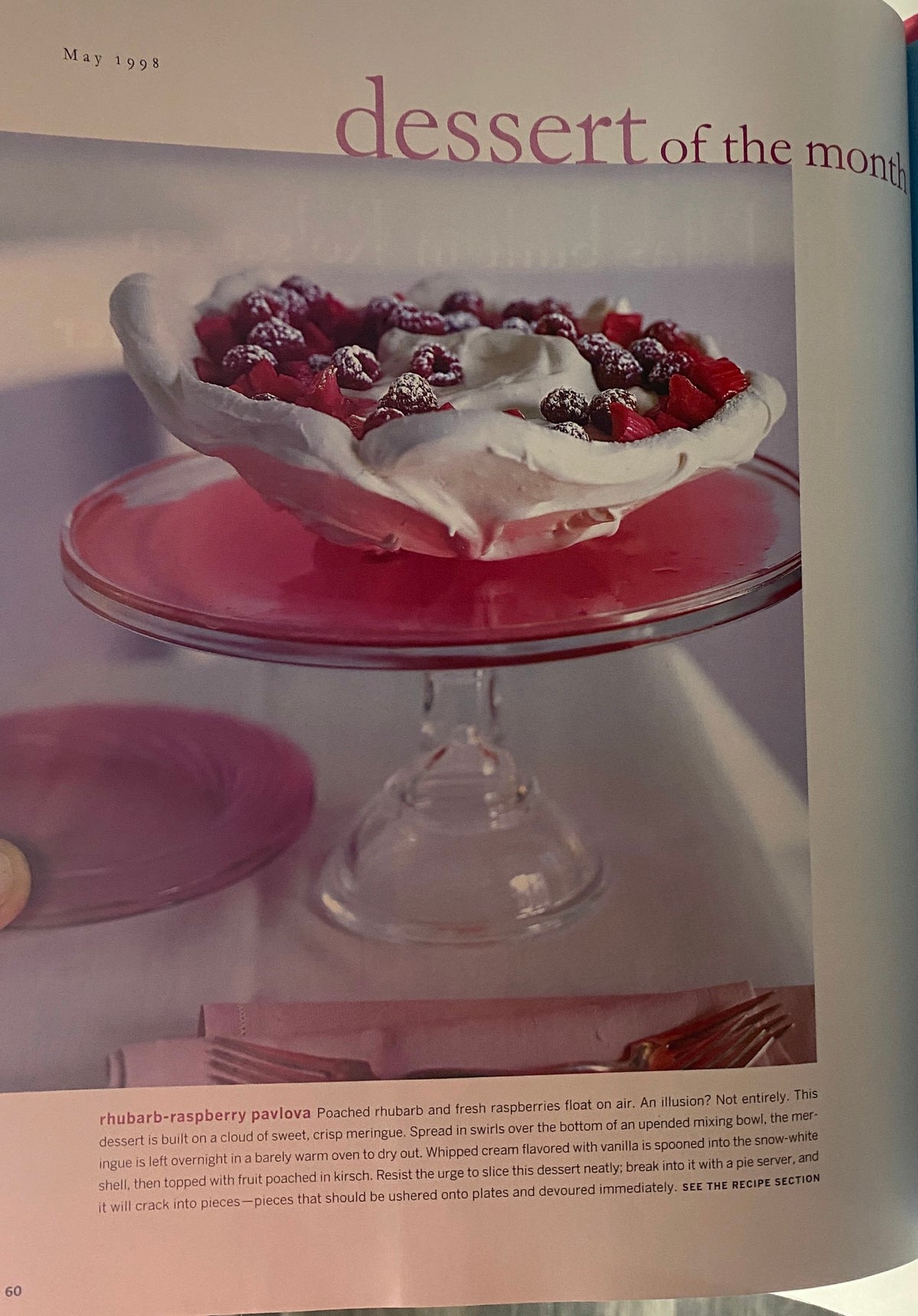 Dessert of the month feature from Martha Stewart Living Magazine May 1998, showcasing a rhubarb-raspberry pavlova on a pink glass dessert stand.