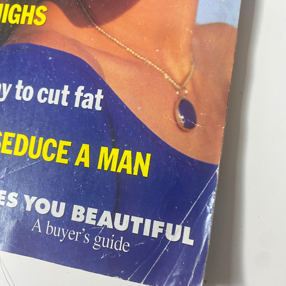 Close-up detail of Self Magazine November 1993 cover showcasing text on beauty and fitness, including 'Diet scoop! A revolutionary new way to cut fat' and 'Lipstick that makes you beautiful: A buyer's guide'.